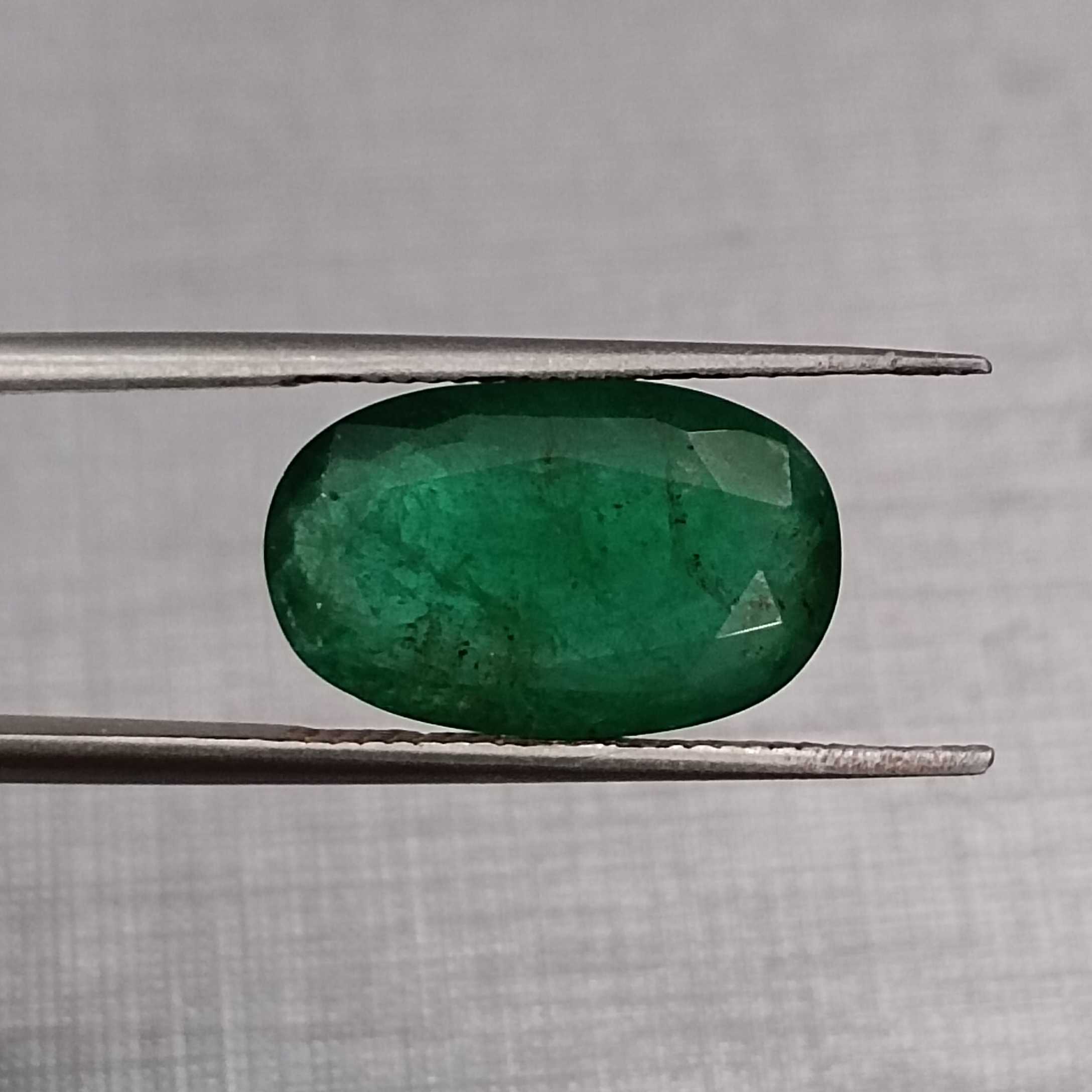 4.36ct deep green elongated oval cut Zambian emerald | Jewelfields