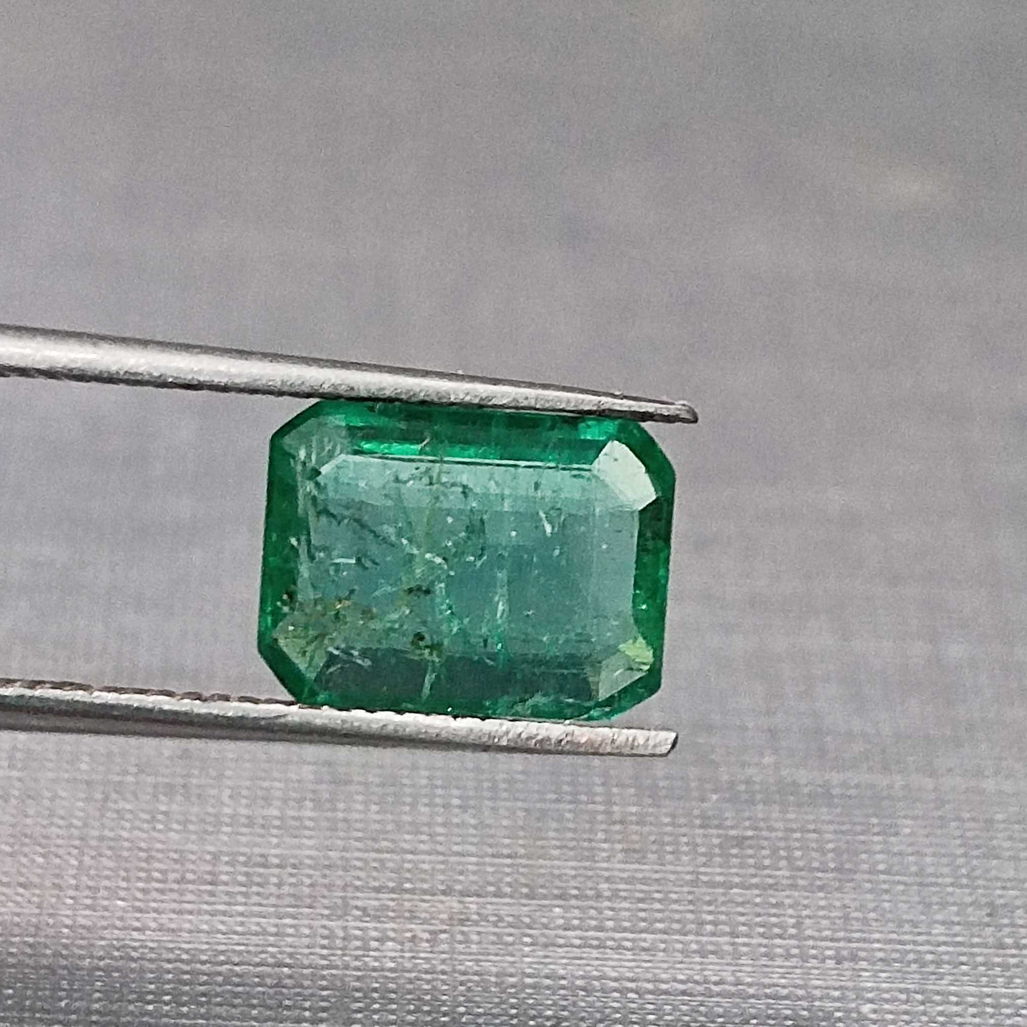 1.75 golden green octagon cut emerald gem. big table