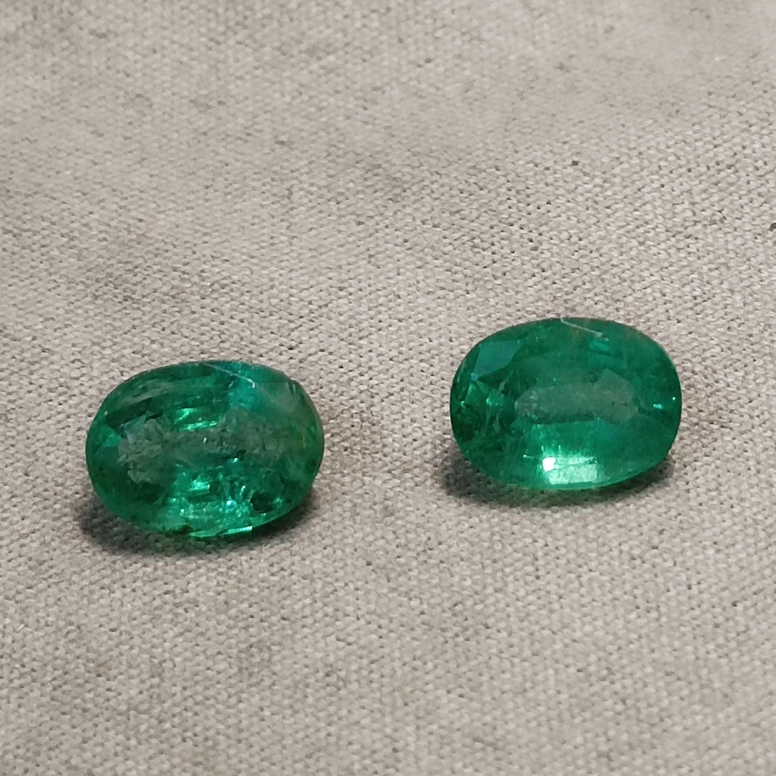 3.55ct vivid green oval mix cut emerald pair