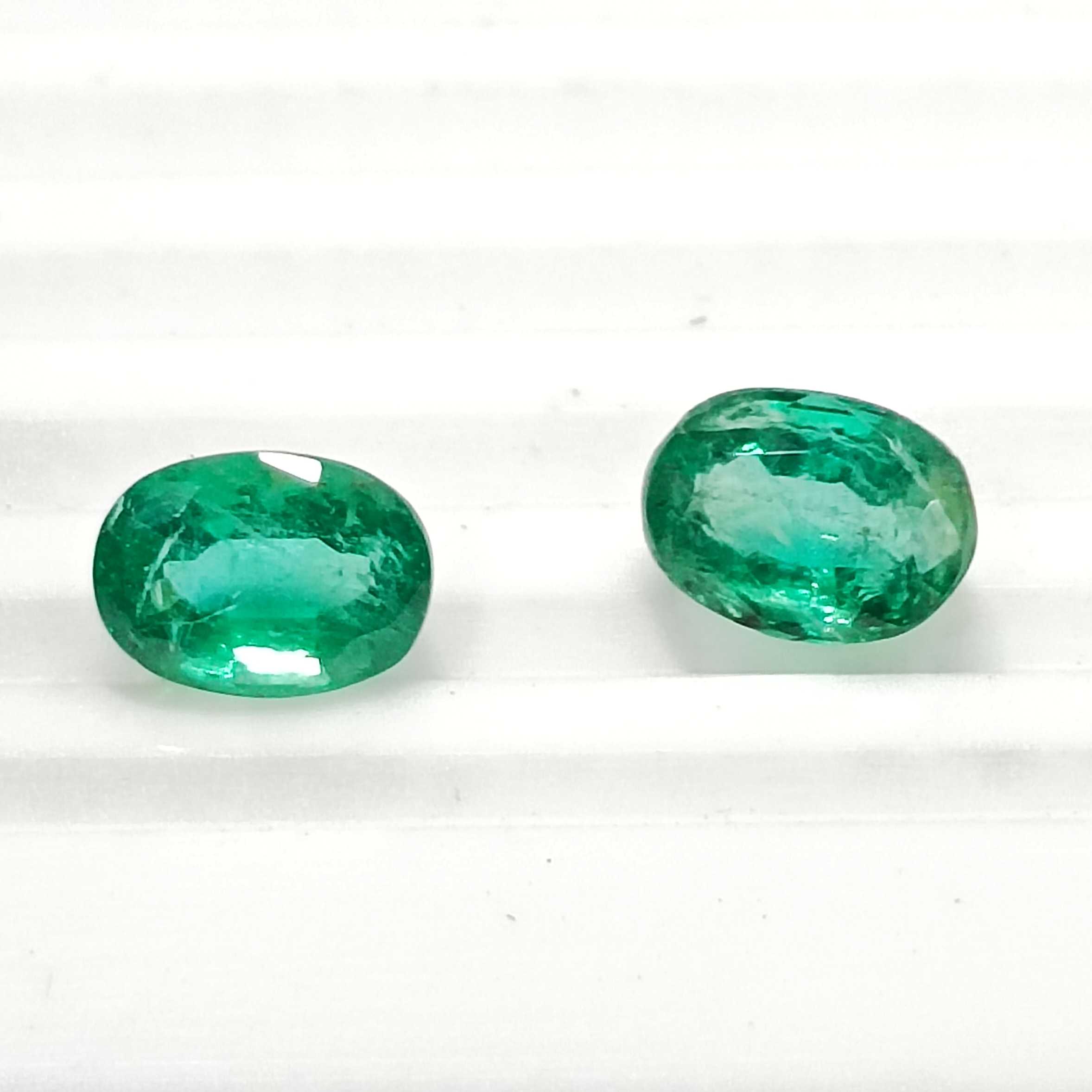 3.55ct vivid green oval mix cut emerald pair