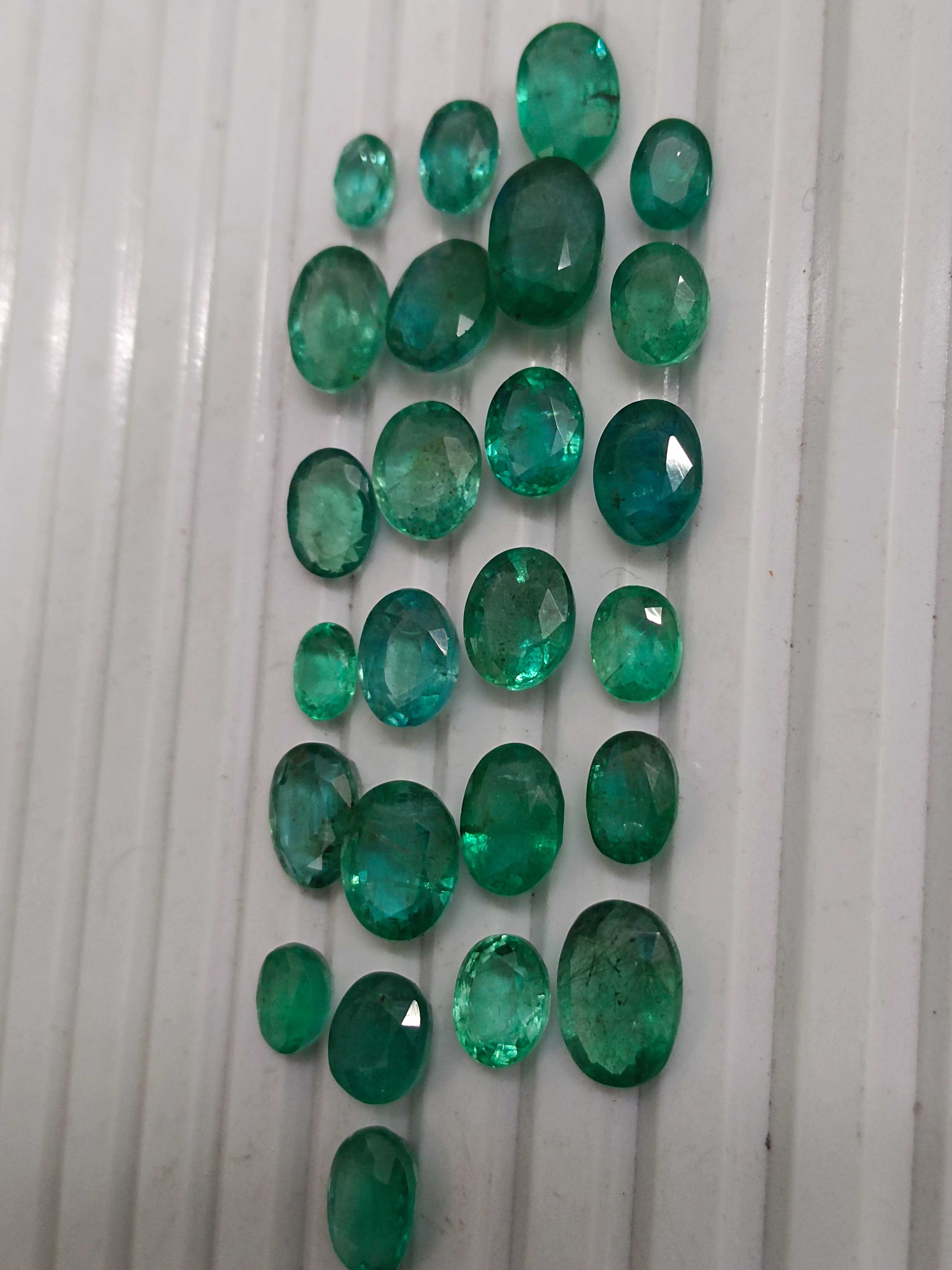 33.76ct oval shaped medium deep green emeralds 