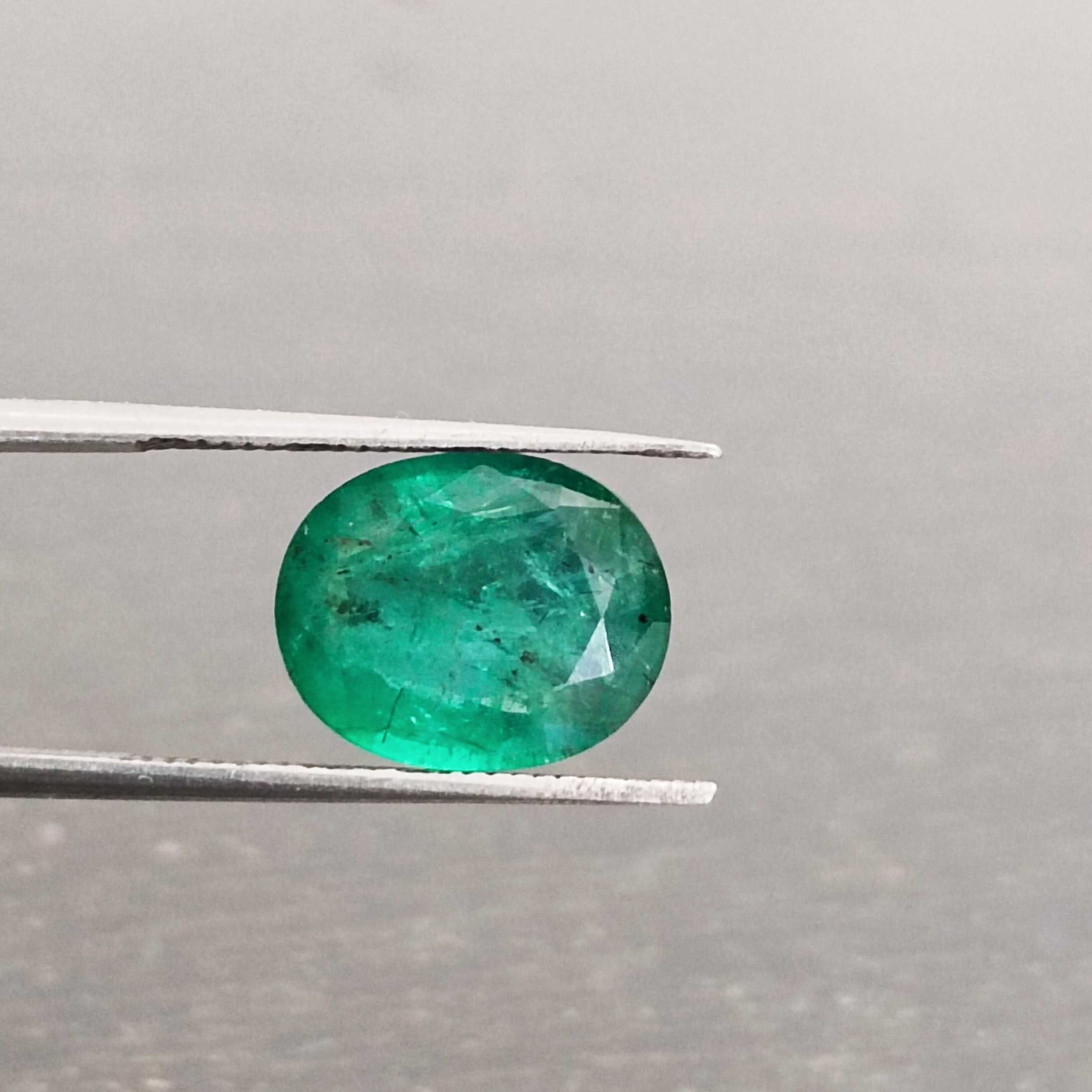 3.57ct deep shiny green oval step cut emerald