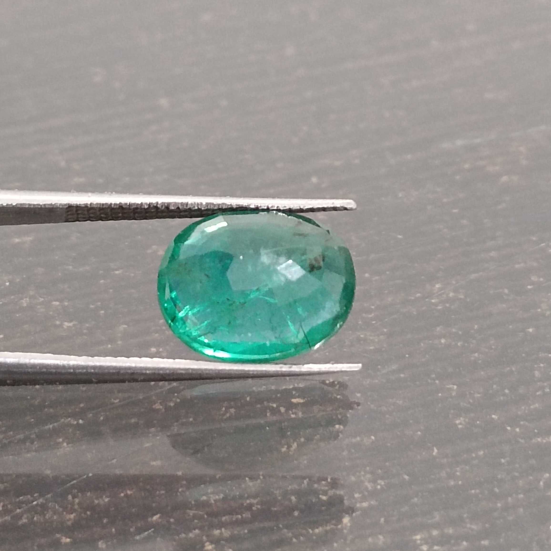3.57ct deep shiny green oval step cut emerald