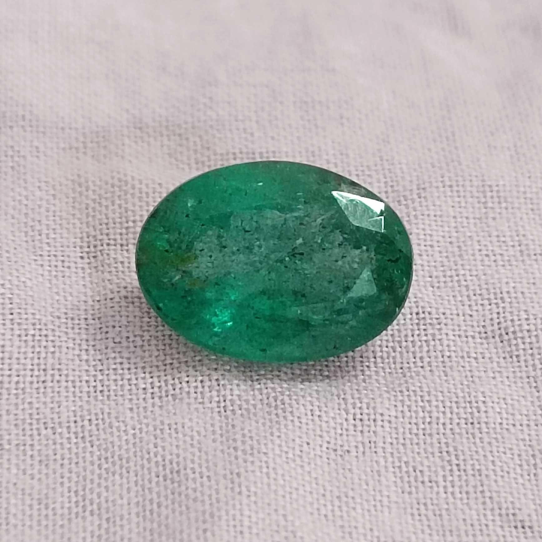 2.88ct deep golden green oval cut emerald