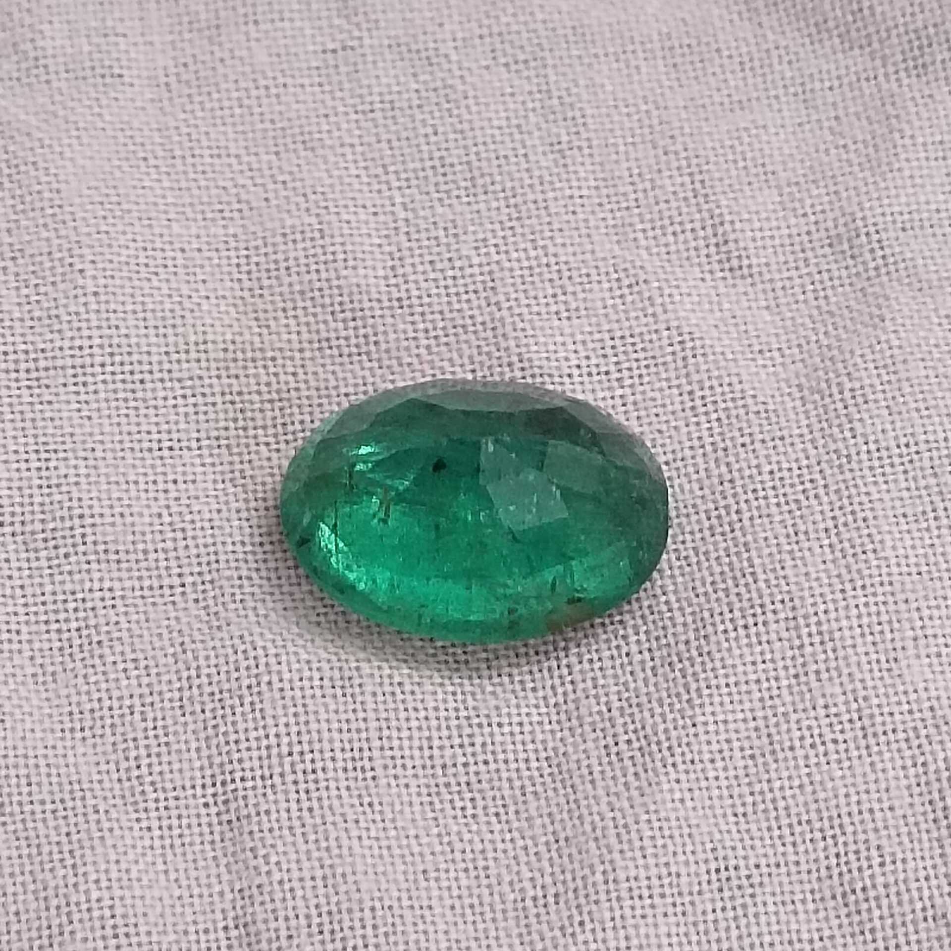 2.88ct deep golden green oval cut emerald