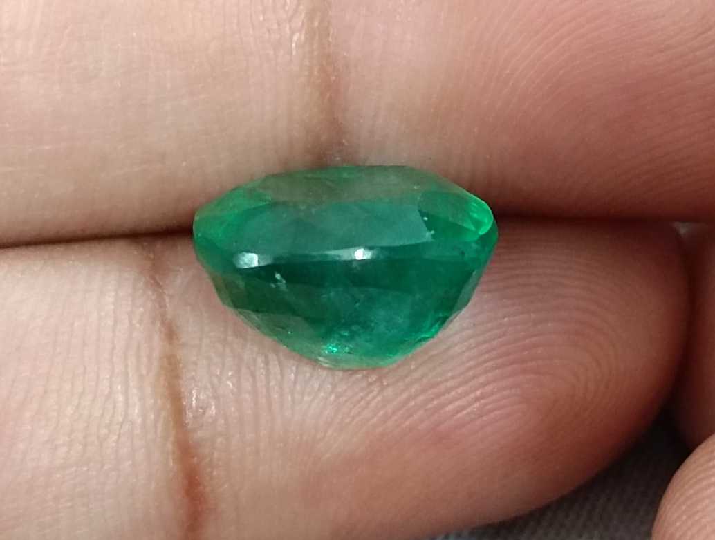 7.30ct Medium Bright green cushion cut Swat emerald.
