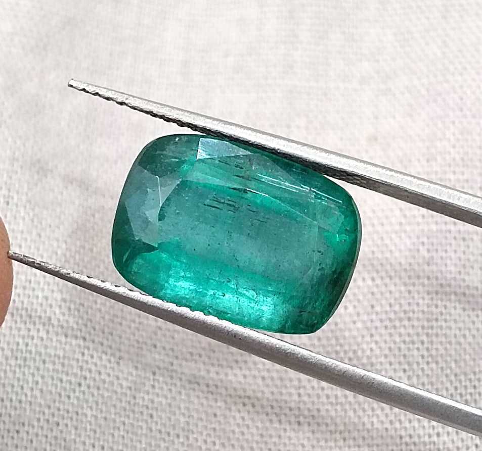 7.34ct Deep slightly bluish green cushion cut Zambian emerald.