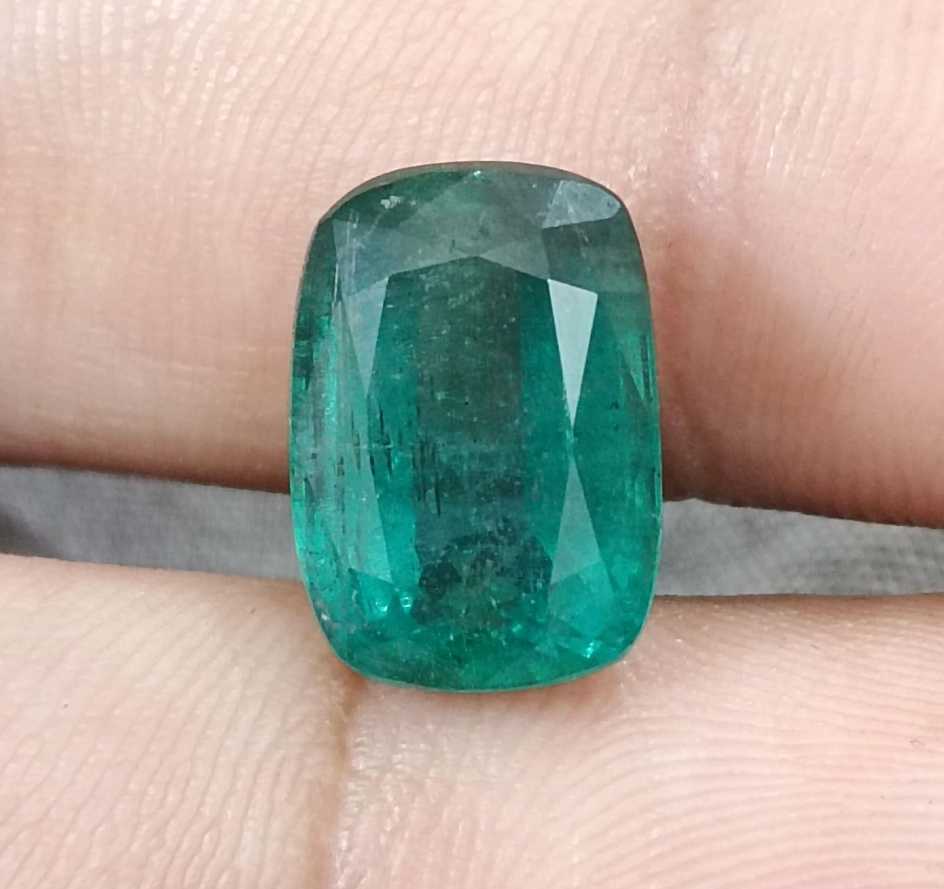 7.34ct Deep slightly bluish green cushion cut Zambian emerald.