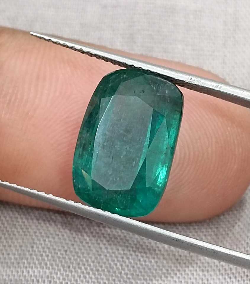 7.34ct Deep slightly bluish green cushion cut Zambian emerald.