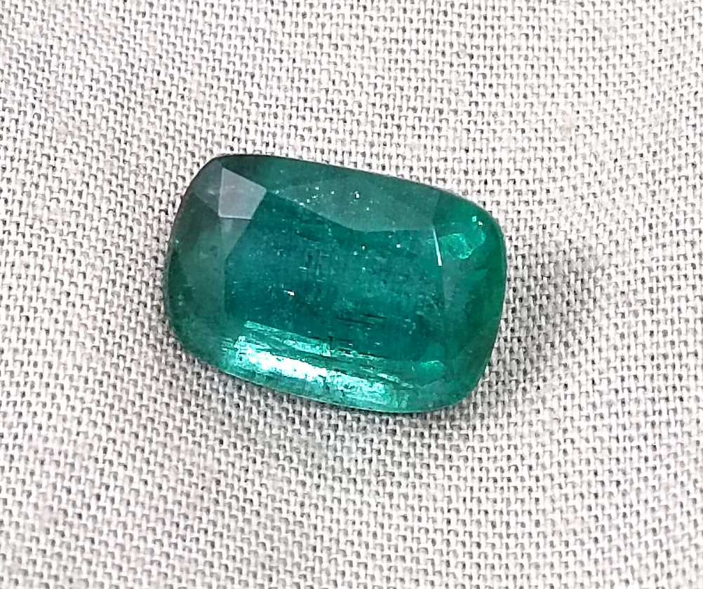 7.34ct Deep slightly bluish green cushion cut Zambian emerald.