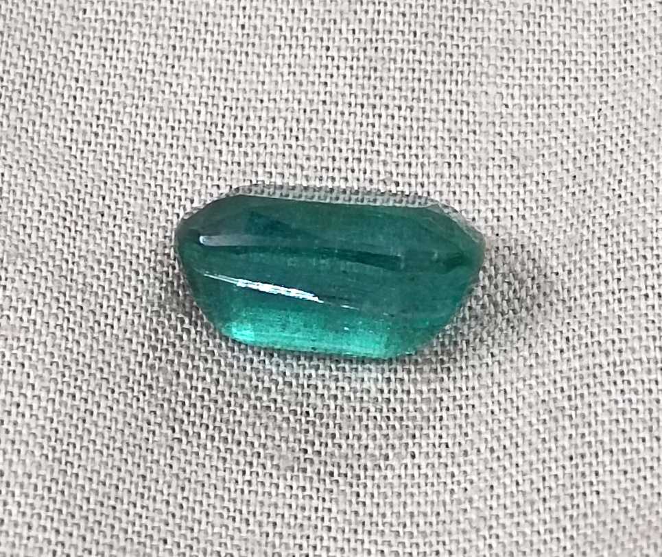 7.34ct Deep slightly bluish green cushion cut Zambian emerald.
