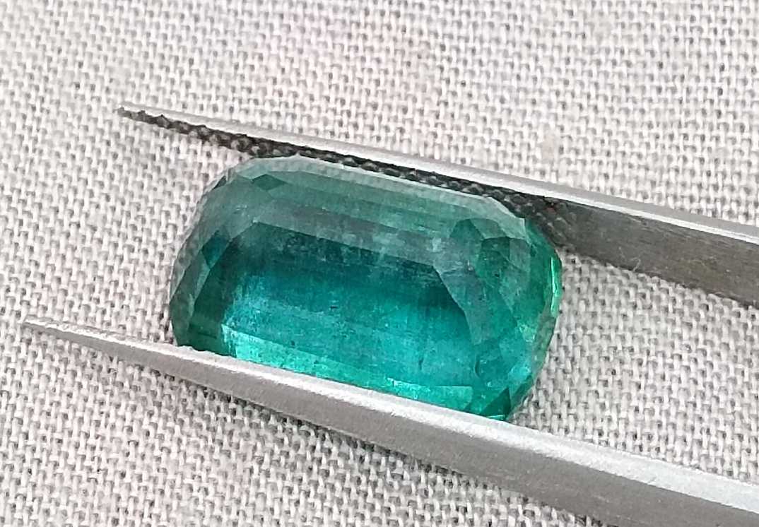 7.34ct Deep slightly bluish green cushion cut Zambian emerald.