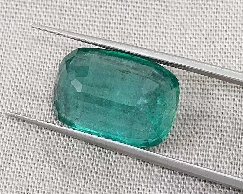 7.34ct Deep slightly bluish green cushion cut Zambian emerald.