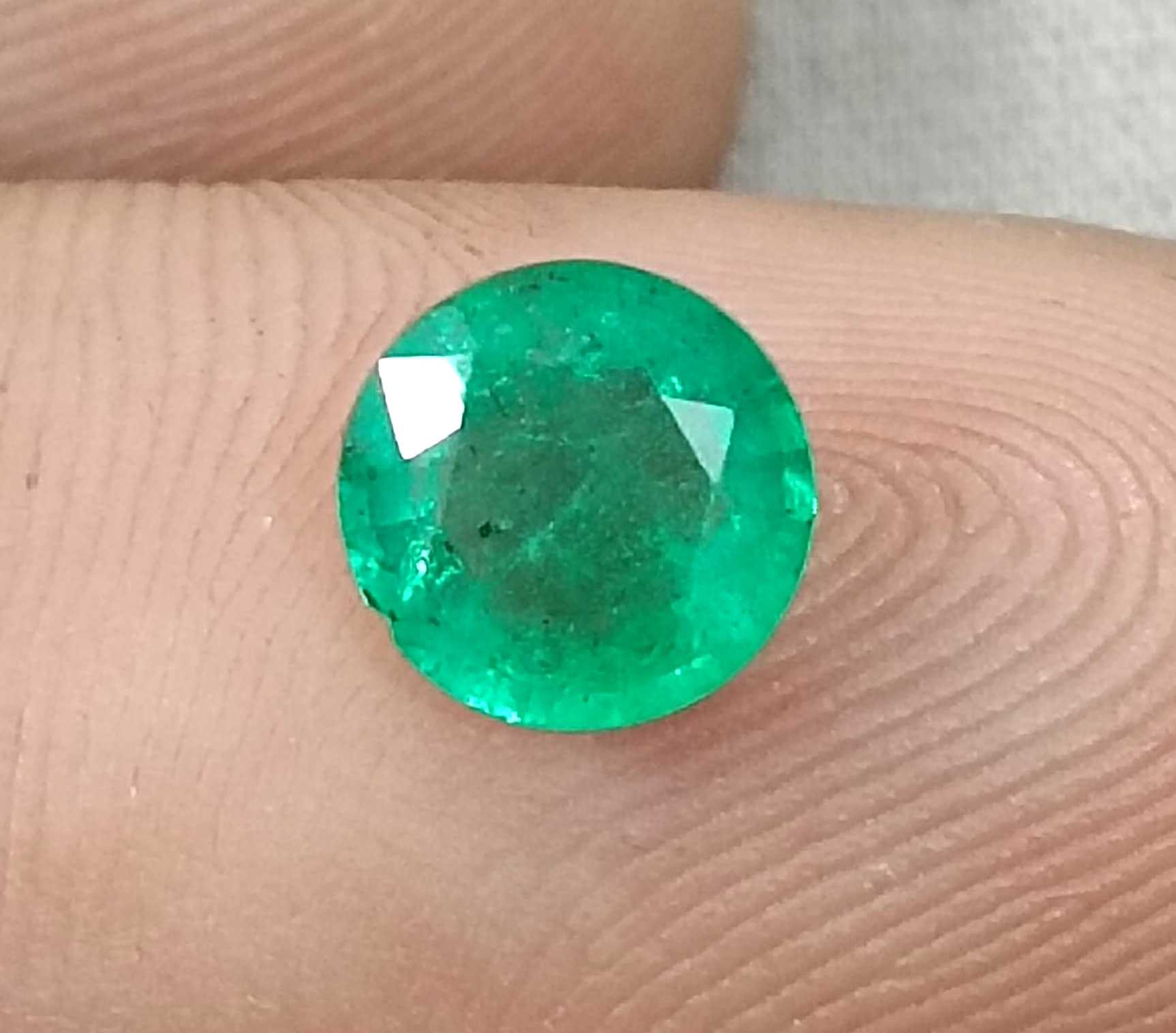1.00ct GSI certified medium bright shamrock green Zambian emerald round cut
