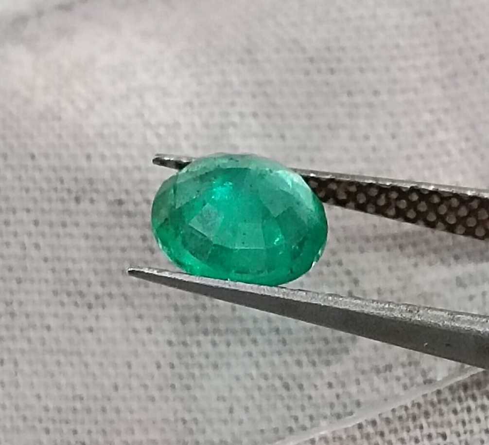 1.00ct GSI certified medium bright shamrock green Zambian emerald round cut
